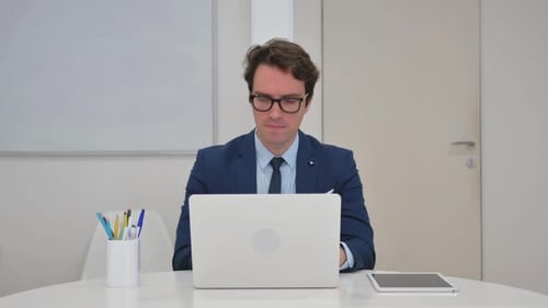 Adult Giving Thumbs Up at Office Desk