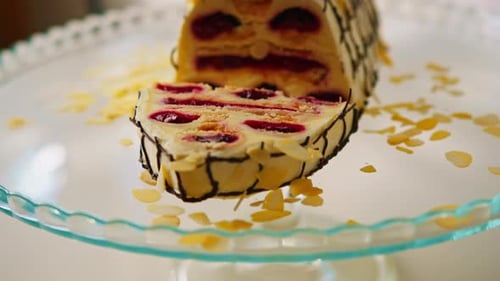 a delicious cherry cake or a monastery hut decorated with almond shavings on a stand cut off a piece