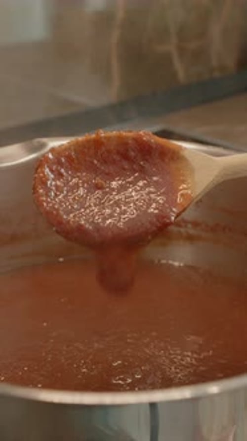 Stirring Homemade Sauce in Pot on Stove