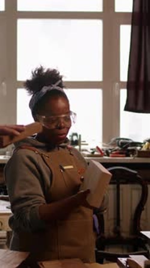 Vertical of Multiethnic Carpenters Doing Woodwork in Workshop