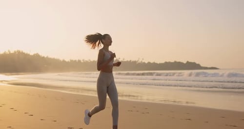 Female Runner Jogging During Outdoor Workout on the Beach in Slow Motion