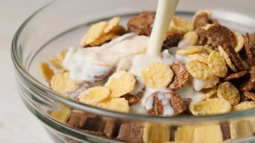 Milk Being Poured into Bowl of Cereal