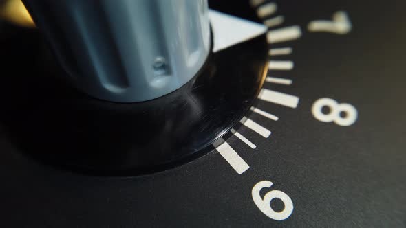 Detail shot. Rotating the variable resistor knob on old equipment on a ...