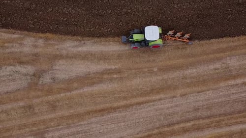 Tractor Plowing Field from Aerial Perspective