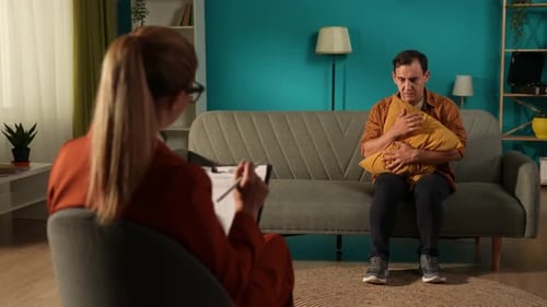 Man Talking with Therapist in Office Setting