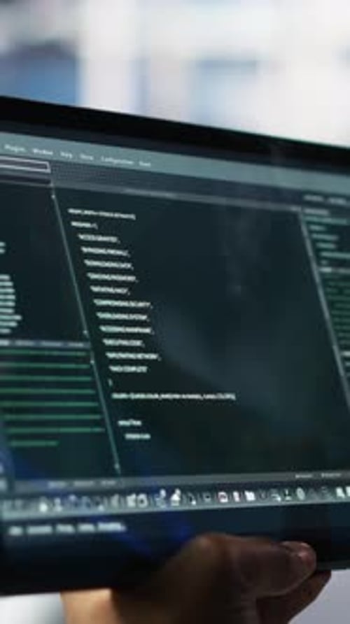 Vertical Video Close Up of Data Center Software Developer Checking Code on Tablet