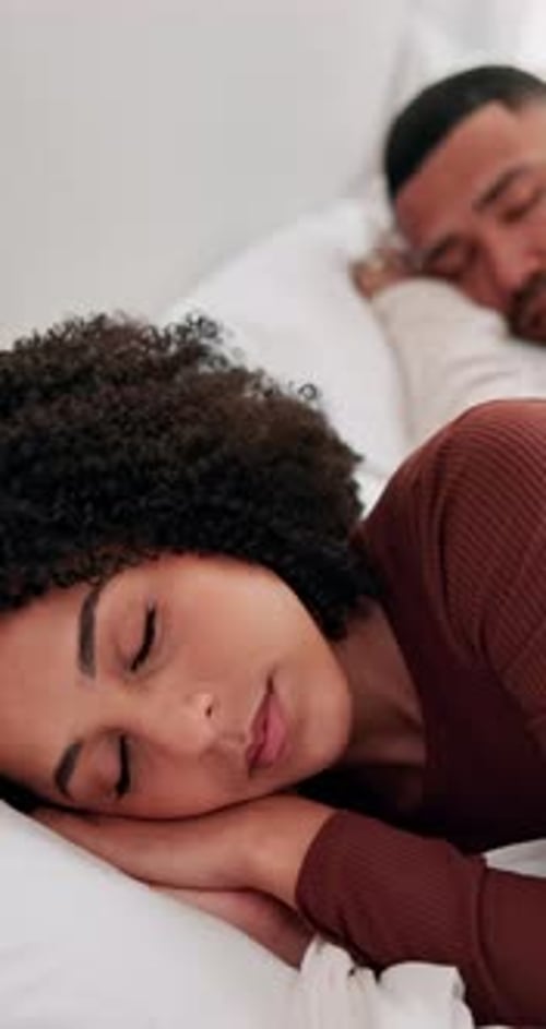 Couple, relax and sleeping in bed for rest, comfort or peaceful morning together at home