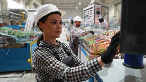 Female Technician Operating CNC Machine in Modern Industrial Factory