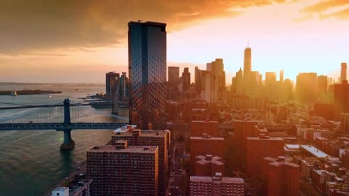 Approaching skyscraper of glass near the Manhattan Bridge and the East River.