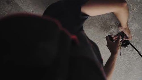 electrician lays electric cable in the apartment, hands close up