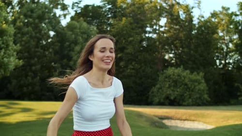 Family Playfully Running and Playing with a Ball Outdoors