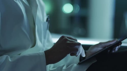 Scientist Using Tablet in Brightly Lit Laboratory