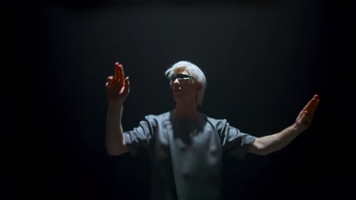Man Interacts with Futuristic Virtual Display in Dark Room