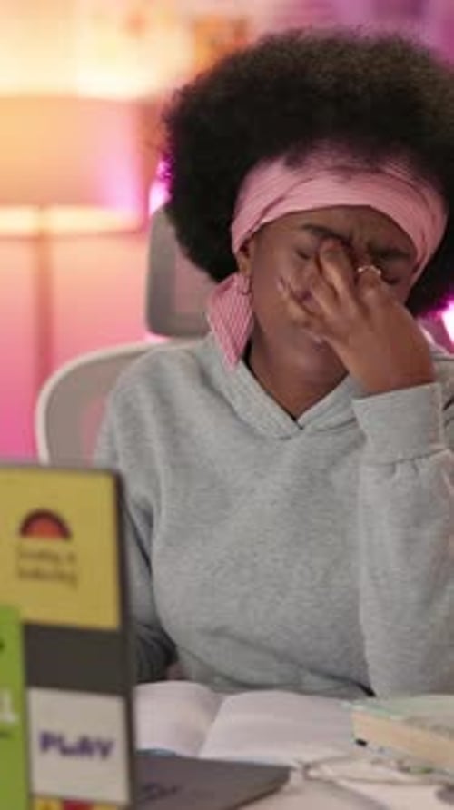 Night, laptop and tired with black woman in bedroom for research assignment