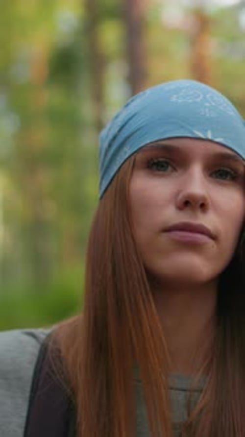 Woman in Blue Bandana Walking Forest Trail with Friend in Calm Atmosphere