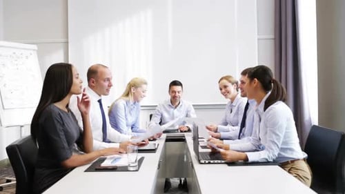 Smiling multiethnic business team celebrates tech success in modern office