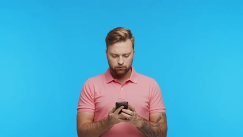 Expressive Young Man with a Smartphone Over Vibrant Background Portrait of Handsome Person