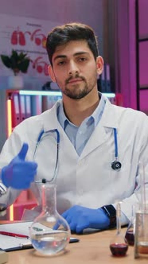 Medical Professional in Lab Coat Gives Thumbs Up
