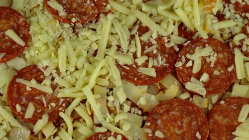 Close up shot of a pepperoni pizza. pepperoni slices and grated cheese. Rotating shot.