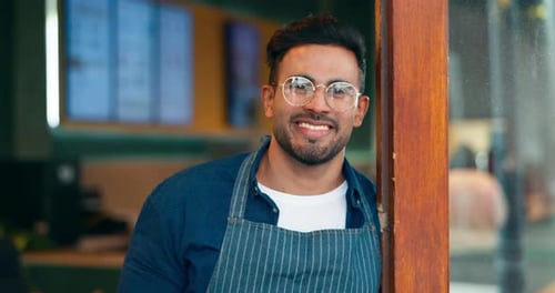 Happiness, entrance and face of coffee shop man, cafe waiter or barista smile for career smile