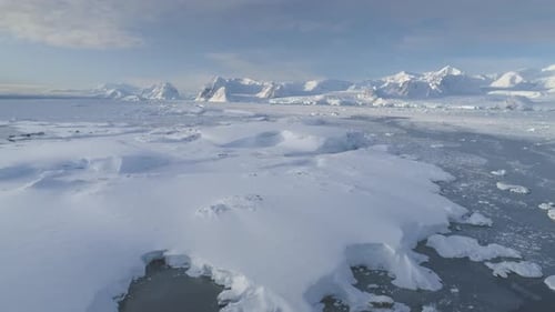 Blue Ice Cave in White Glacier on Antarctic Peninsula Aerial Shot Closeup
