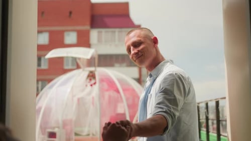 Pair Strolls Towards Transparent Floralenclosed Structure Two Individuals Walk Hand in Hand Towards