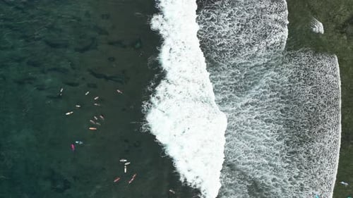 Aerial view of ocean waves and surfers, Philippines.