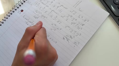 Solving Math Homework with Pen on Lined Paper