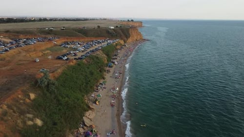 Aerial View of Sandy Beach Swimming People in Sea Bay with Transparent Blue Water at Sunset in