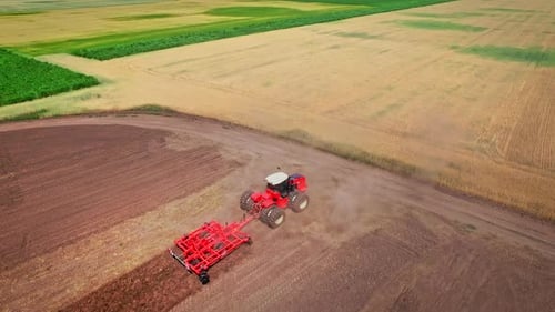Aerial View Agricultural Machinery Working in Field. Agricultural Tractor on Farming Field