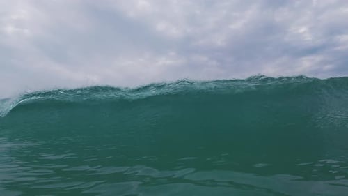 Ocean wave breaks on the shore. Wave rolls and breaks over the coastal area. Underwater camera