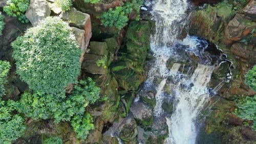 Aerial drone footage of a tall rocky waterfall in the Yorkshire Dales, Pennies. Moorland scene of a