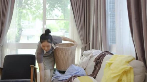 Woman with Laundry Basket in Sunny Living Room