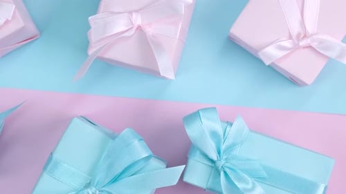 Pastel Gift Boxes on Pink and Blue Background