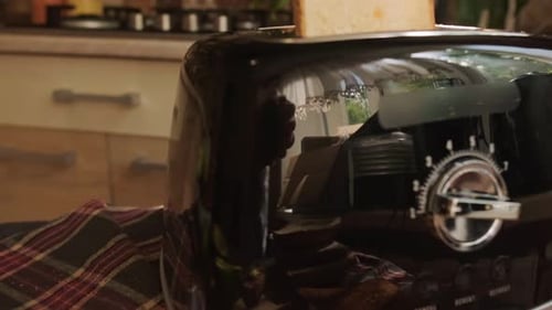 Close-up of Toasting Bread Slices in Black Toaster