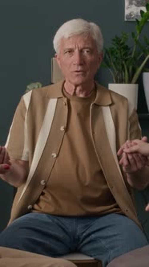 Man Speaking in a Group Holding Hands