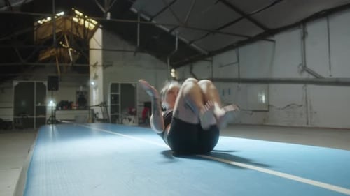 Girl Practicing Artistic Gymnastics Skills in a Gym