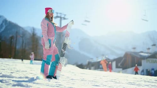 Woman Snowboarding in Snowy Mountain Landscape