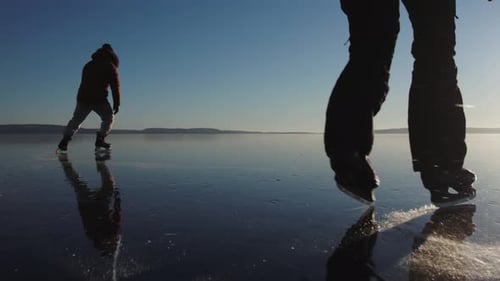 Ice Skating on Frozen Lake in Winter Sunlight