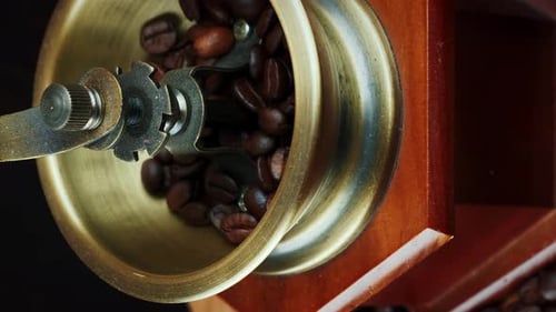Coffee beans are falling into vintage coffee machine
