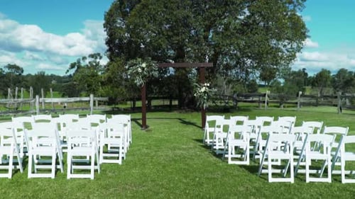Wedding Place With Wooden Arch And White Chairs For Outdoor Wedding Ceremony - wide shot