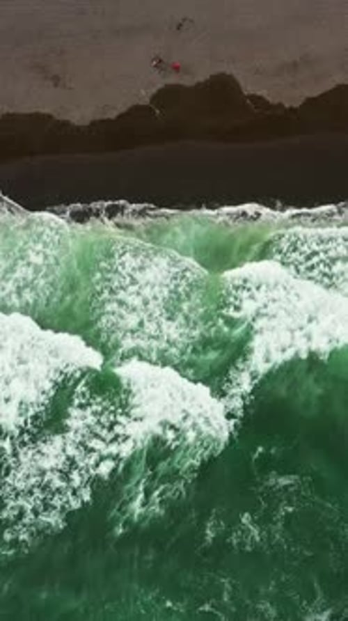 Aerial top view of beach with black sand