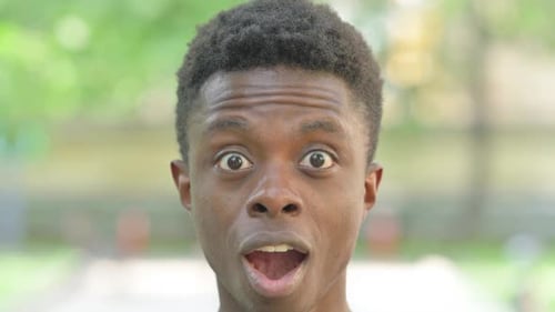 Close-up of a Excited Young African Man Surprised Face