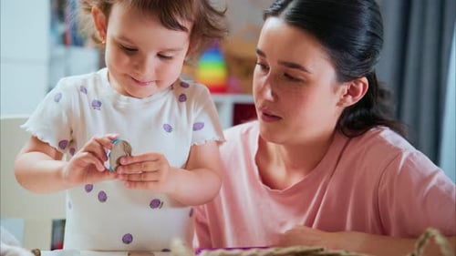 Young Child and Adult Woman Crafting at Home