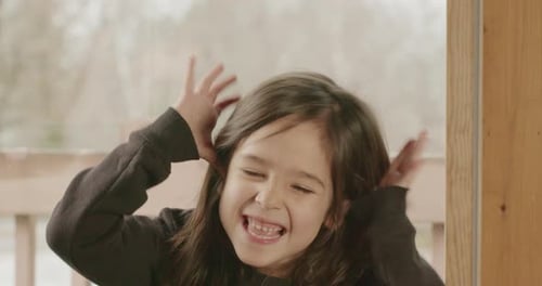 A small Latina girl taunts someone.