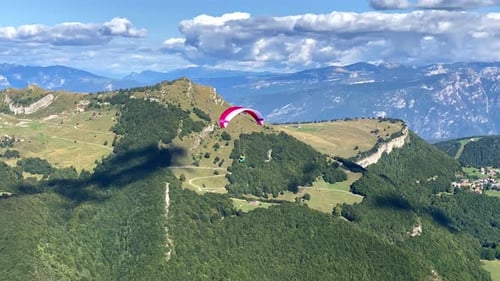 Paraglider take off and flying above mountains