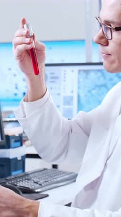 Scientist Analyzing Blood Sample in Modern Laboratory
