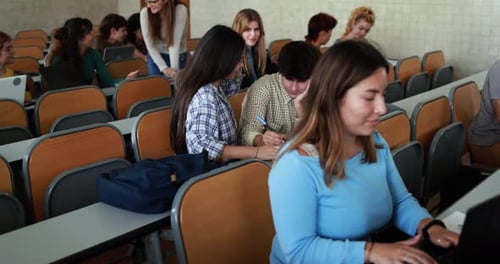 Mature Teacher Working with Students Inside Classroom at School University Academic
