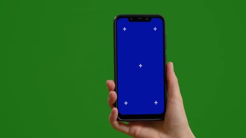 Female with blue chroma key screen phone in hands watching promo on green screen background.