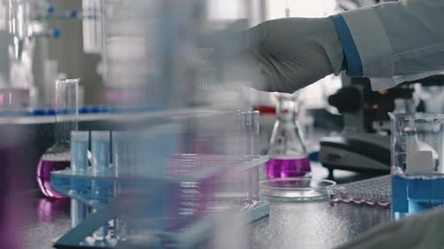Lab Researcher Using Pipette on Test Tubes